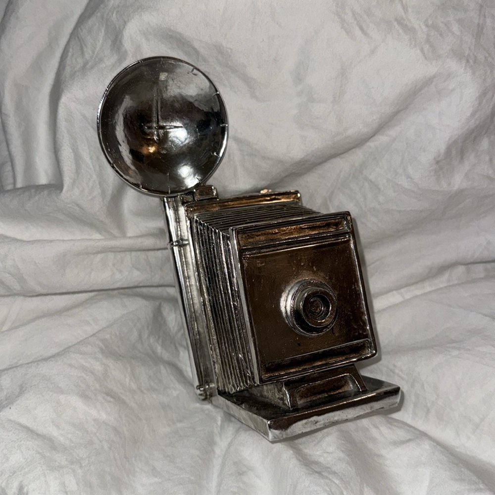 Silver-colored old fashioned vintage camera decor.